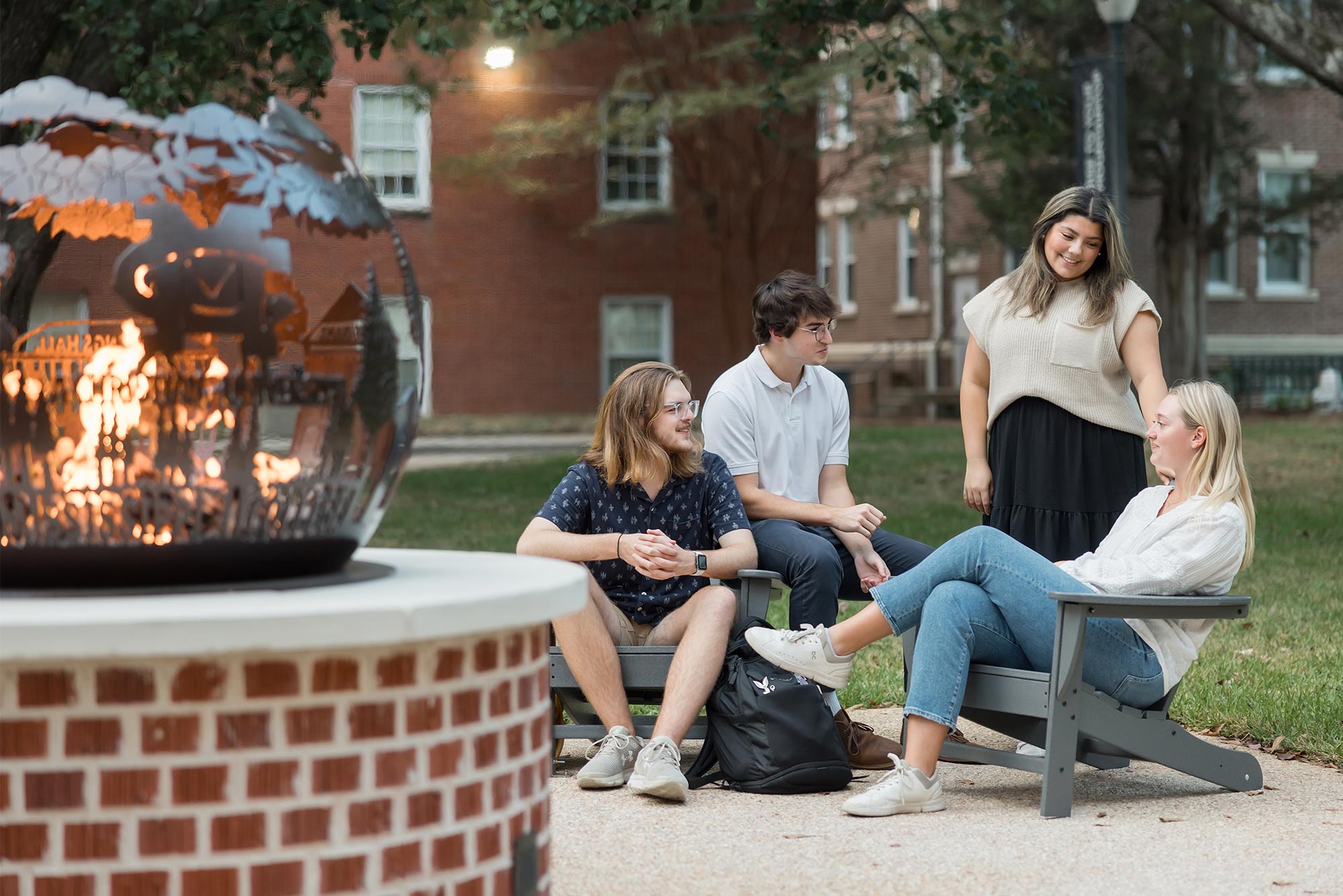 counseling students socializing around a fire pit