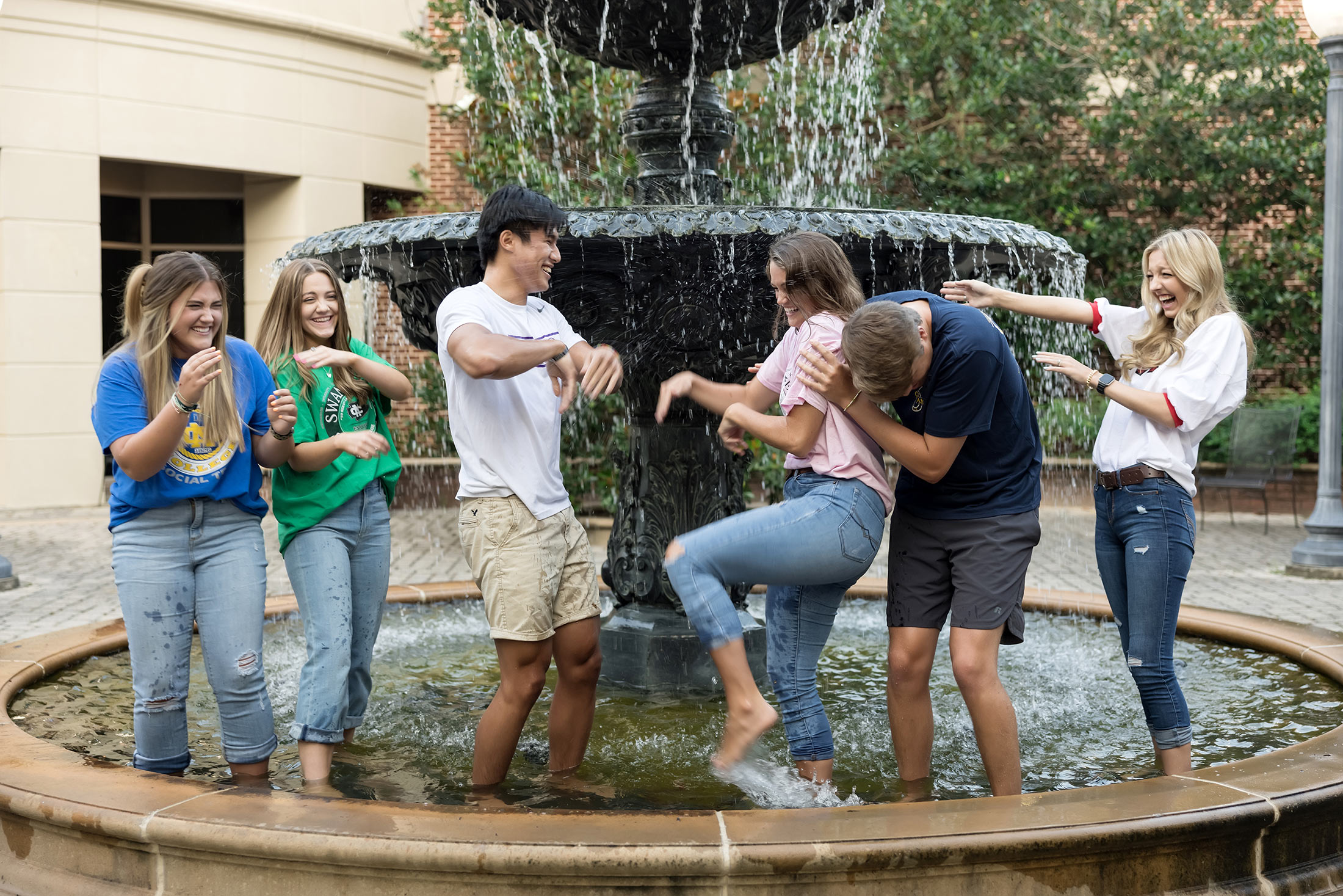 Students having fun in fountain