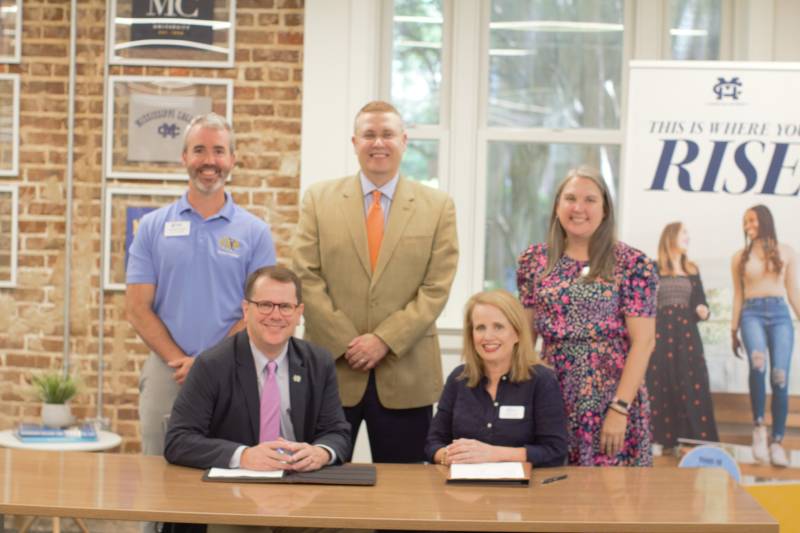 On hand to witness MC President Blake Thompson and Christ Covenant School Dean of Advisement Cheri Creel sign the MOU are, from left, Michael Wright, MC dean of enrollment services, Michael J. Highfield, MC provost and executive vice president, and Kristy Hawkins, CCS math teacher.