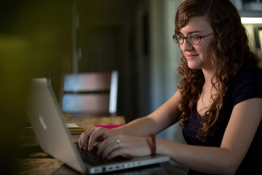 A student happily reviews her Facebook friend requests.